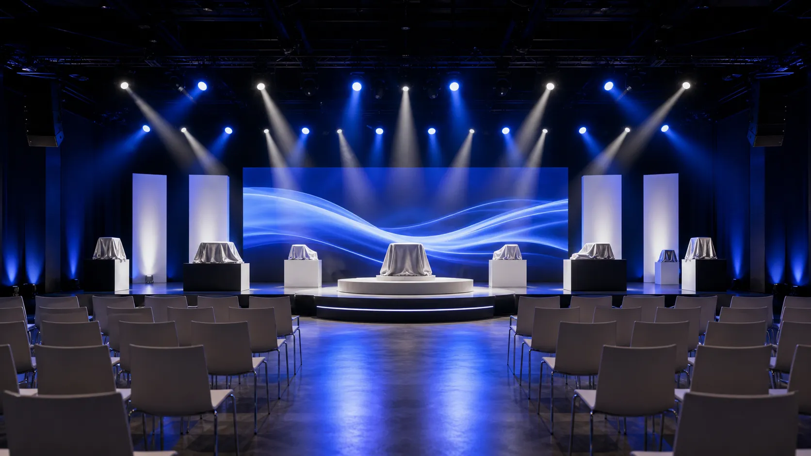 A product reveal stage washed in cobalt light